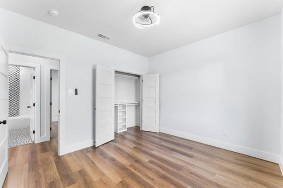 Unfurnished bedroom with light wood-style flooring and a closet Unfurnished bedroom with light wood-style flooring and a closet