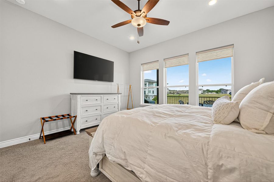 Serene primary suite with soft neutral palette, plush carpet, and large windows overlooking the lake. Serene primary suite with soft neutral palette, plush carpet, and large windows overlooking the lake.