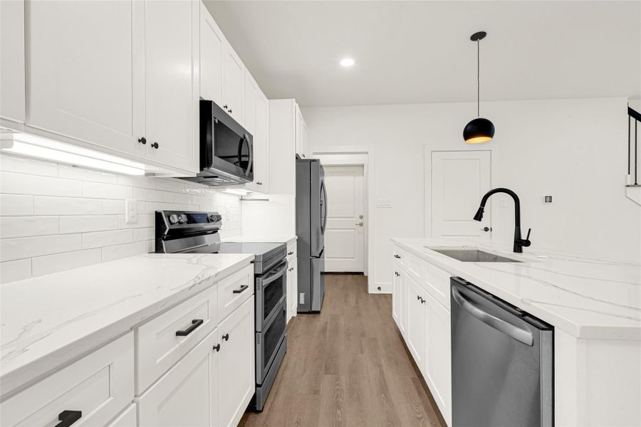 The kitchen offers plenty of cabinetry and counter space for entertaining and everyday living.