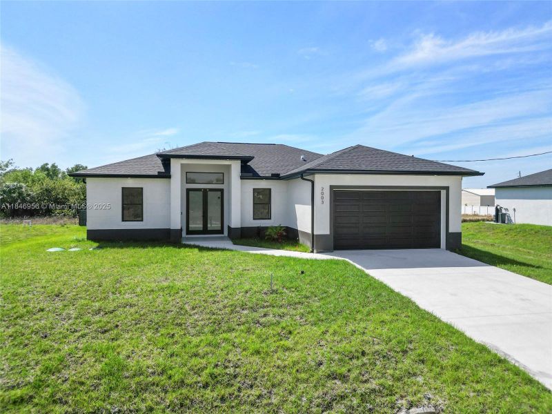 Front exterior of a new home in , Lehigh Acres, FL, highlighting curb appeal (Image 1).