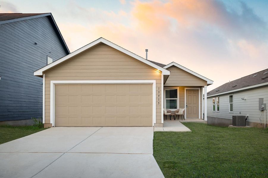 View of front of property with driveway, a yard, and an attached garage View of front of property with driveway, a yard, and an attached garage