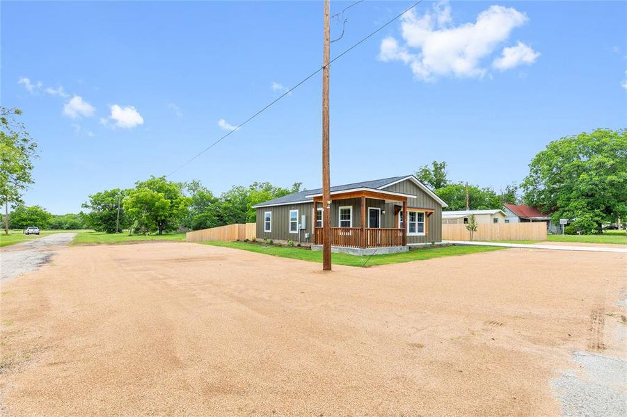 View of front of house featuring dirt driveway and covered porch View of front of house featuring dirt driveway and covered porch