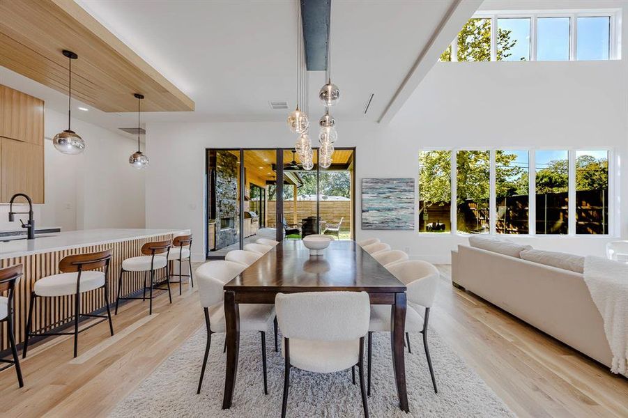 Dining space featuring a chandelier and light wood-type flooring Dining space featuring a chandelier and light wood-type flooring