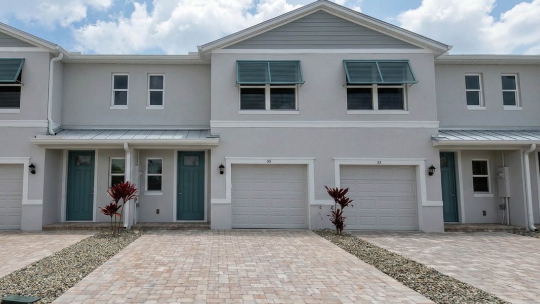 Front exterior of a new home in Tortuga Cay, Satellite Beach, FL, highlighting curb appeal (Image 1). Front exterior of a new home in Tortuga Cay, Satellite Beach, FL, highlighting curb appeal (Image 1).