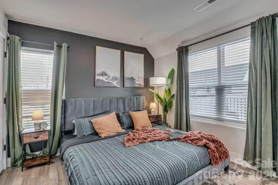 The spacious primary suite offers a peaceful retreat with abundant natural light, soaring ceilings, designer accent wall, and plenty of room to relax and unwind. The spacious primary suite offers a peaceful retreat with abundant natural light, soaring ceilings, designer accent wall, and plenty of room to relax and unwind.
