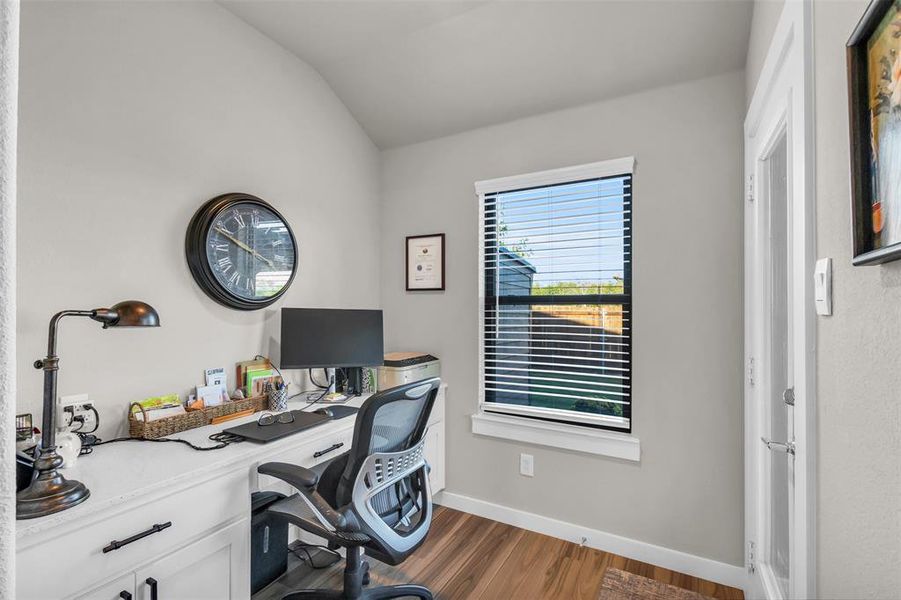 Office featuring dark hardwood / wood-style floors and lofted ceiling