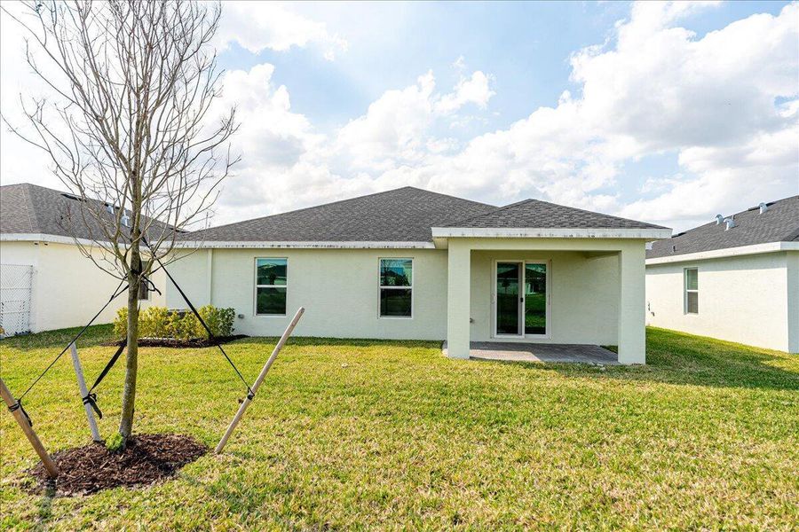 Front exterior of a new home in Brystol at Wylder: The Heritage Collection, Port St. Lucie, FL, highlighting curb appeal (Image 15).