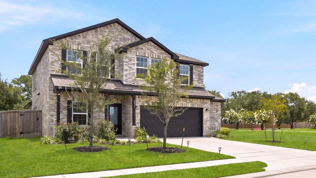 Front exterior of a new home in Massey Oaks, Pearland, TX, highlighting curb appeal (Image 2).