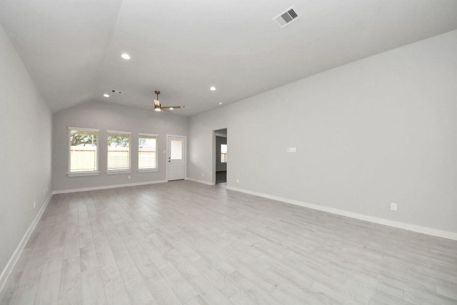 Take another glimpse into the heart of the home with this additional view of the family room—a sprawling space ready to accommodate all your gatherings. Sample photo of completed home with similar floor plan. Actual colors and selections may vary.