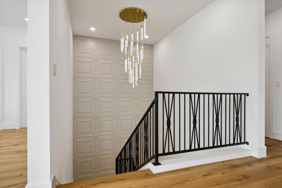 Statement designer chandelier and accent two-story wall lead the way to the second floor. Statement designer chandelier and accent two-story wall lead the way to the second floor.