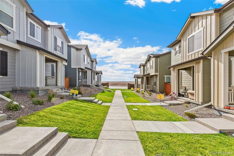 Front exterior of a new home in Sky Ranch Villas, Watkins, CO, highlighting curb appeal (Image 22).