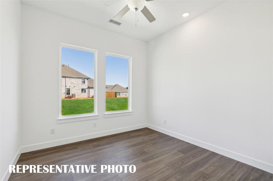 Oversized windows flood this wonderful home office with natural light!  REPRESENTATIVE PHOTO