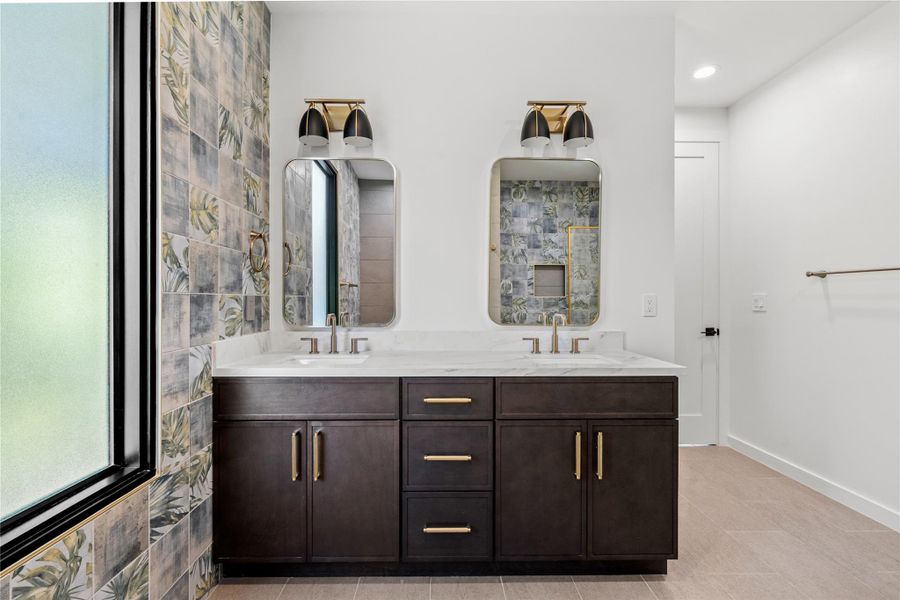 Full bath with double vanity and light tile patterned floors
