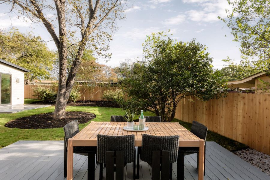 Deck with outdoor dining space and a fenced backyard Deck with outdoor dining space and a fenced backyard