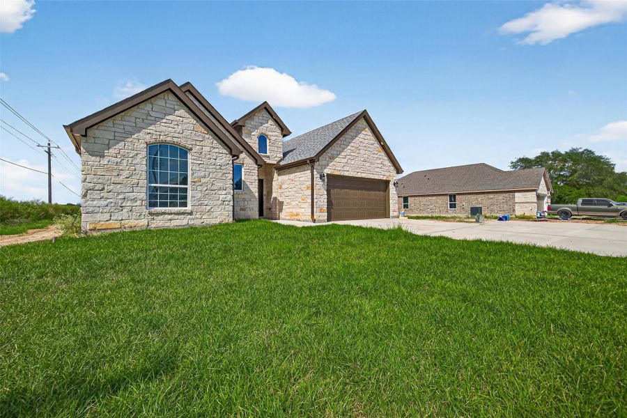 Front exterior of a new home in , Prairie View, TX, highlighting curb appeal (Image 27).