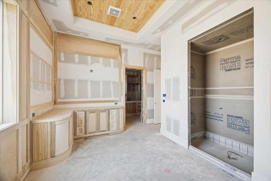 This angle reveals the future soaking tub and walk-in shower areas, framed to support premium tile and slab selections. The ceiling detail adds architectural interest that will elevate the final design. A beautifully planned primary bath built for comfort and style.