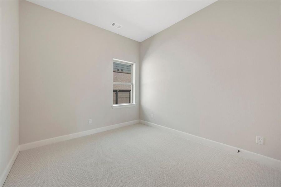 Neutral-toned walls complement light-colored carpet flooring