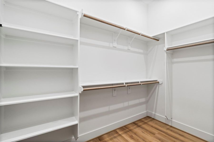 Two spacious walk-in his-and-hers closets offer ample storage and a personal haven for organization, making the primary suite as practical as it is luxurious. Two spacious walk-in his-and-hers closets offer ample storage and a personal haven for organization, making the primary suite as practical as it is luxurious.