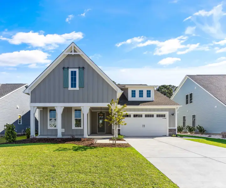 Representative exterior photo of a completed home built from the The Sutton by RobuckHomes in Windwater, Hampstead, NC (Image 1). Representative exterior photo of a completed home built from the The Sutton by RobuckHomes in Windwater, Hampstead, NC (Image 1).