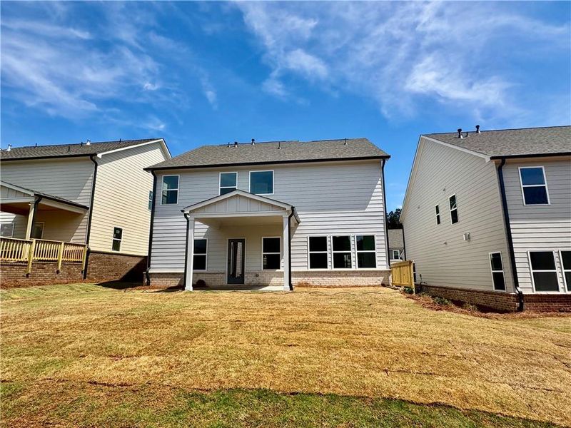 Exterior details and patio area of a home in Eastlyn Crossing, Flowery Branch (Image 17).