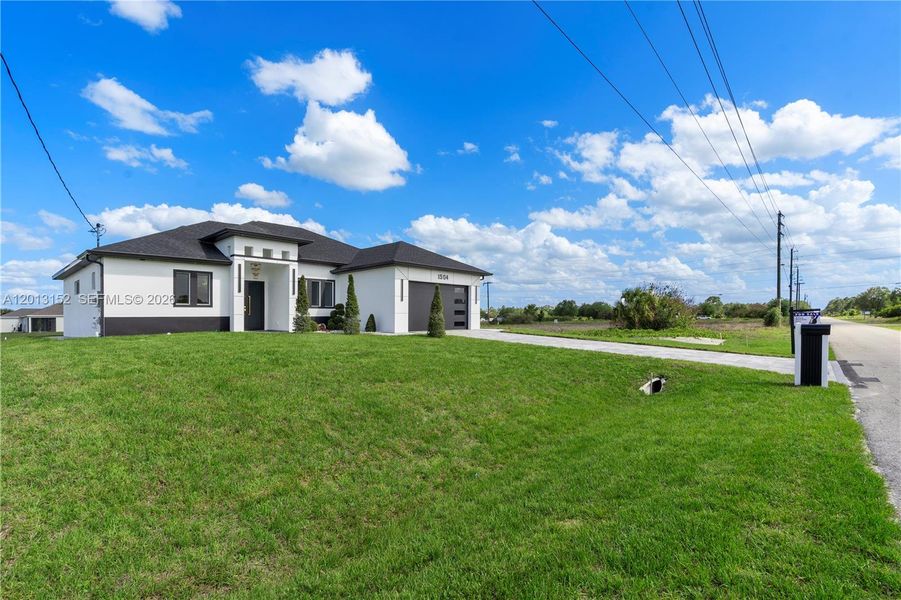 Front exterior of a new home in , Lehigh Acres, FL, highlighting curb appeal (Image 29).