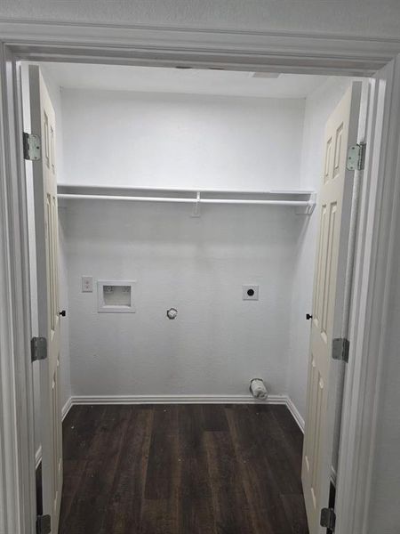 Laundry area featuring electric dryer hookup, hookup for a gas dryer, dark wood-type flooring, and washer hookup Laundry area featuring electric dryer hookup, hookup for a gas dryer, dark wood-type flooring, and washer hookup