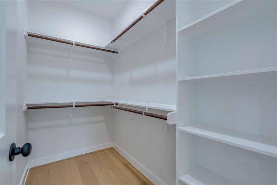 Plenty of shelving and hanging space in this well-organized walk-in closet.