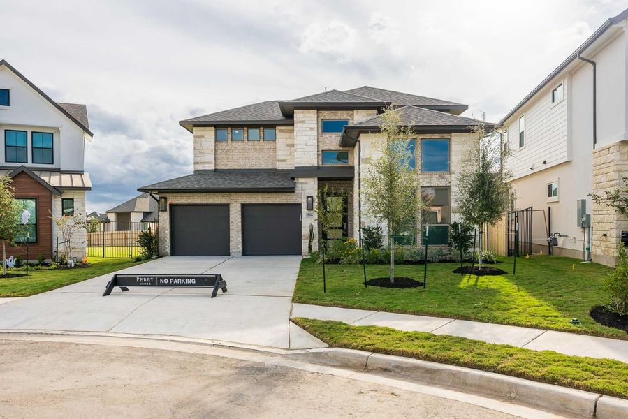 Front exterior of a new home in Santa Rita Ranch 50', Liberty Hill, TX, highlighting curb appeal (Image 1). Front exterior of a new home in Santa Rita Ranch 50', Liberty Hill, TX, highlighting curb appeal (Image 1).