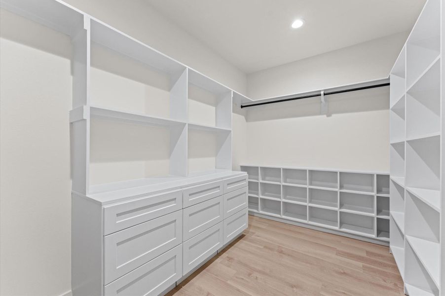 The primary closet is 13x8 with custom shelves/drawers on all 4 walls.