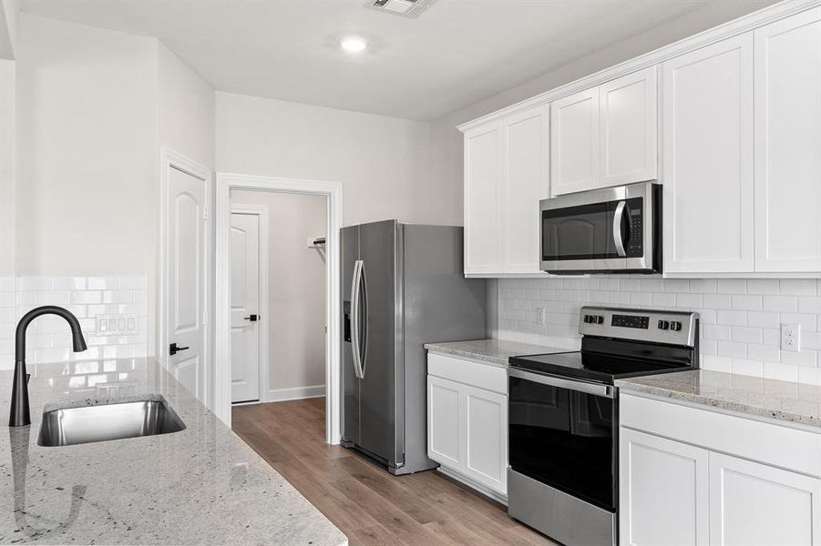 Kitchen featuring New Whirlpool appliances.