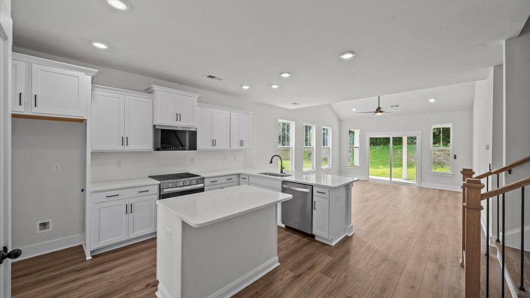 Vibrant kitchen layout with a center island, refined finishes, and open-concept flow