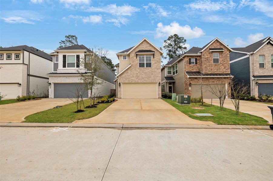Front exterior of a new home in The Woodlands Hills, Willis, TX, highlighting curb appeal (Image 2). Front exterior of a new home in The Woodlands Hills, Willis, TX, highlighting curb appeal (Image 2).
