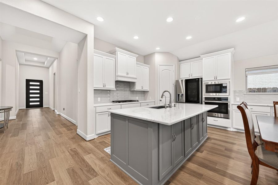 Beautiful gourmet kitchen featuring upgraded quartz countertops, built-in appliances, and elegant cabinetry with crown molding. Thoughtfully designed with soft-close pull-out drawers, this space combines luxury, functionality, and timeless style Beautiful gourmet kitchen featuring upgraded quartz countertops, built-in appliances, and elegant cabinetry with crown molding. Thoughtfully designed with soft-close pull-out drawers, this space combines luxury, functionality, and timeless style