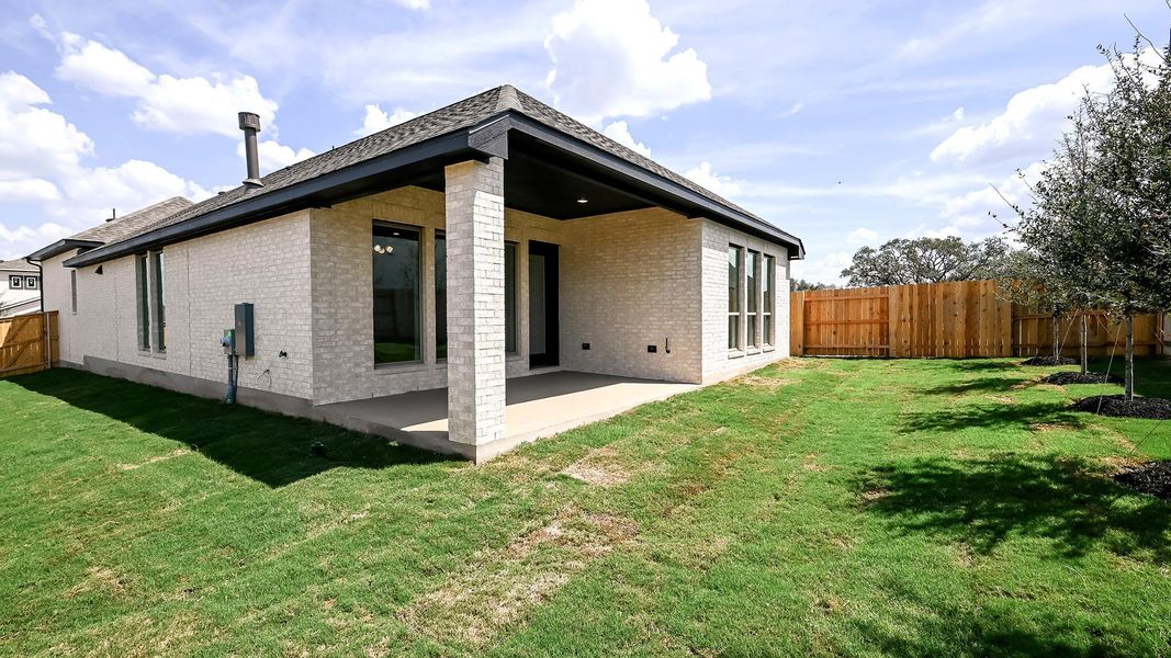 Rear view of house featuring a fenced backyard, brick siding, and a patio area Rear view of house featuring a fenced backyard, brick siding, and a patio area