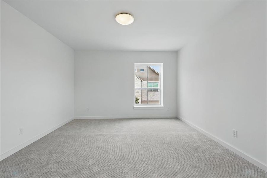 Unfurnished room with light colored carpet and baseboards