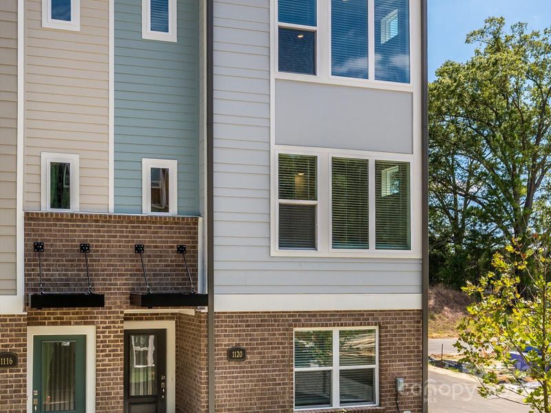 Front exterior of a new home in Central Living at Craig, Charlotte, NC, highlighting curb appeal (Image 22).