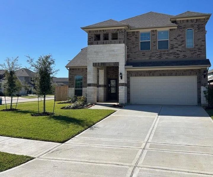 Front exterior of a new home in Stone Creek Ranch, Hockley, TX, highlighting curb appeal (Image 1).