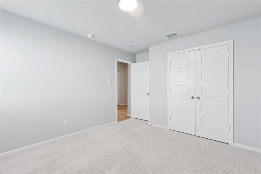 Bedroom in the Harrison home plan by Trophy Signature Homes – REPRESENTATIVE PHOTO Bedroom in the Harrison home plan by Trophy Signature Homes – REPRESENTATIVE PHOTO