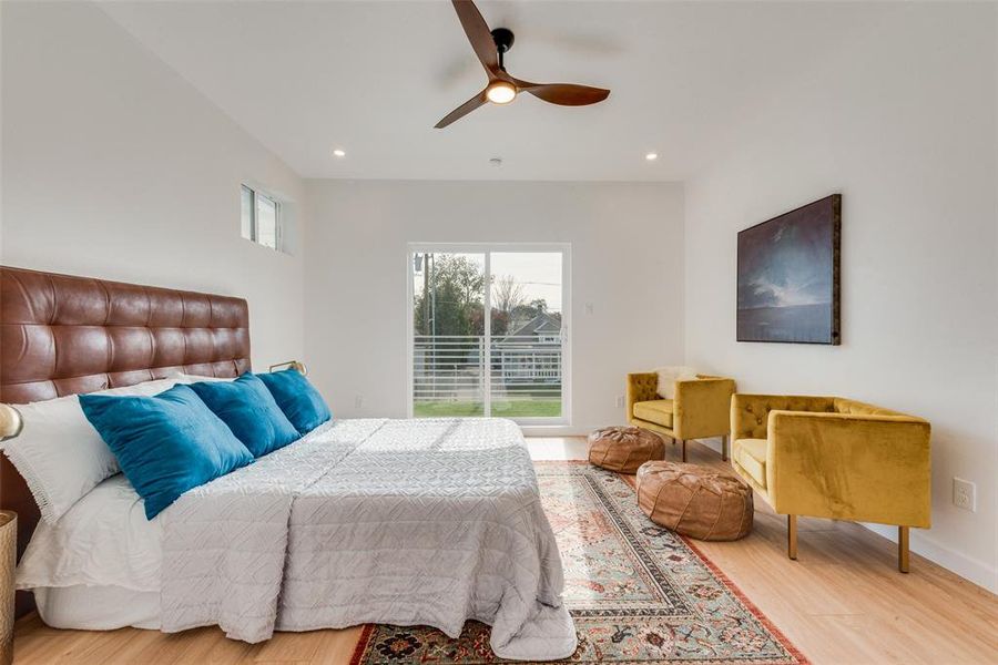 Bedroom with ceiling fan and hardwood / wood-style floors