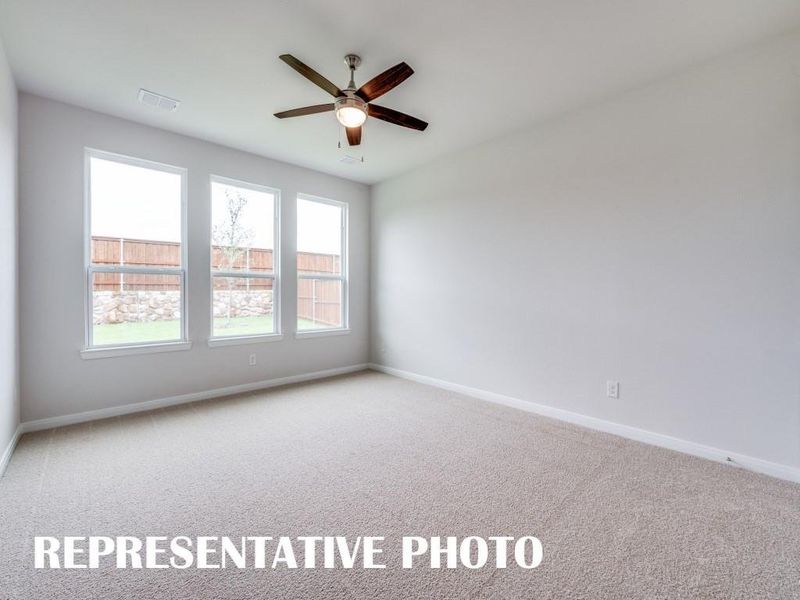 Featuring oversized windows, plush carpeting and a neutral color palette, this owner's suite was designed for rest and relaxation.  REPRESENTATIVE PHOTO