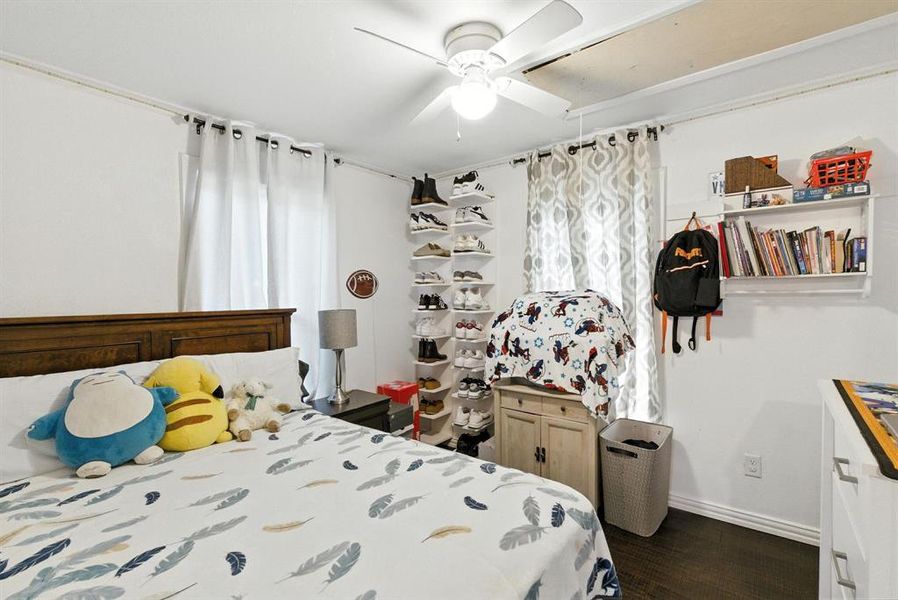Bedroom with dark wood finished floors and ceiling fan