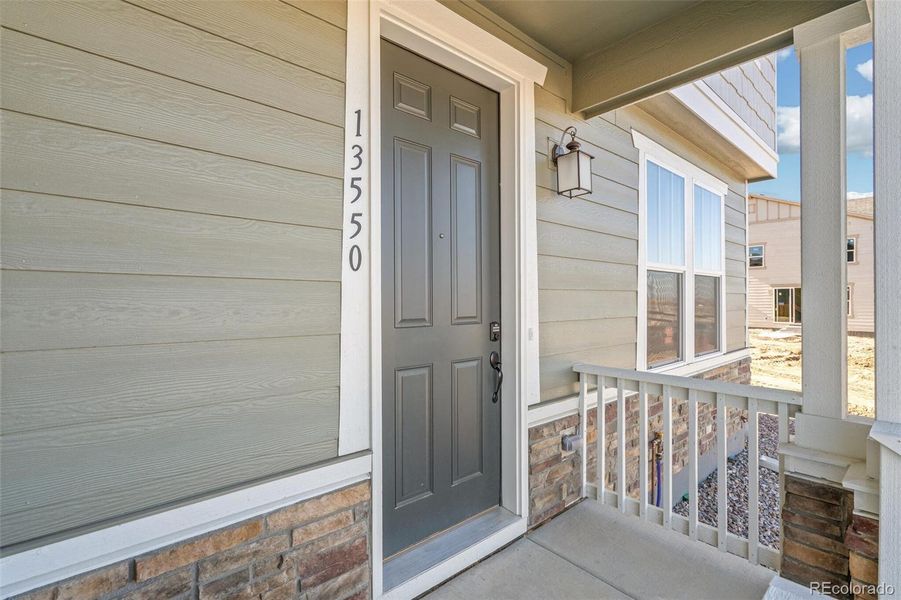 Exterior details and patio area of a home in Turnberry, Commerce City (Image 24).
