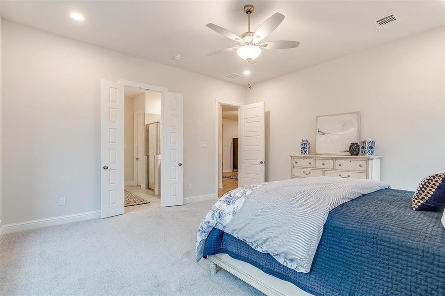 Bedroom featuring ceiling fan and light colored carpet