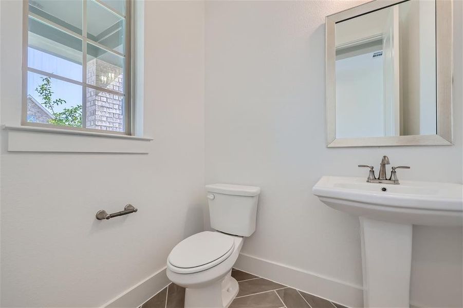 Bathroom featuring tile patterned floors and toilet