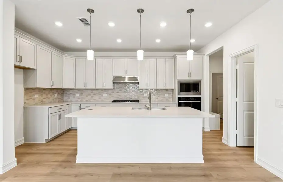 Spacious kitchen with eat-in bar top island