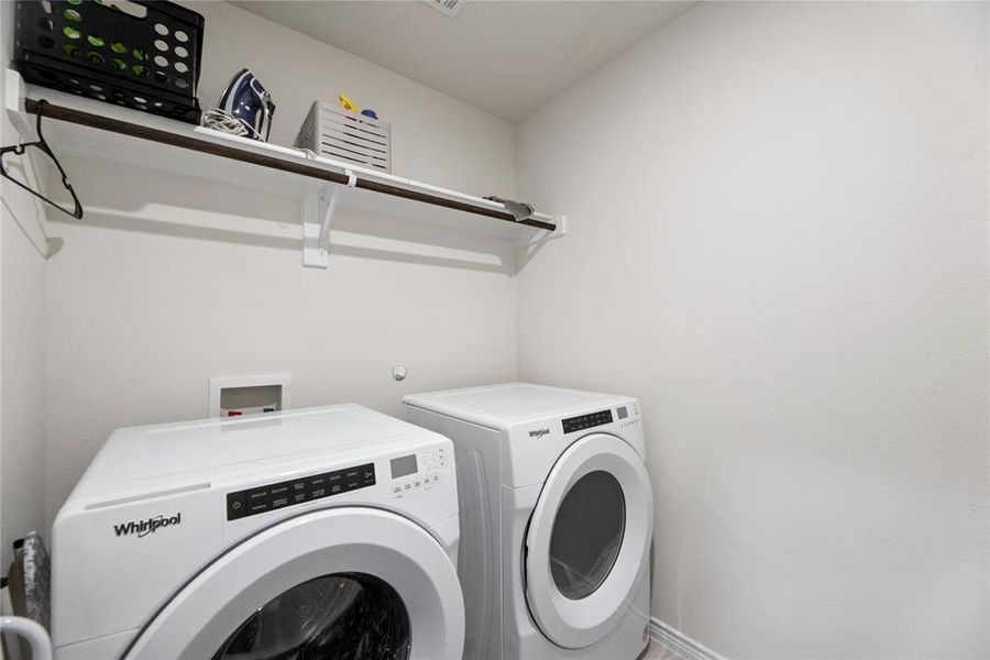 Washroom featuring separate washer and dryer and baseboards