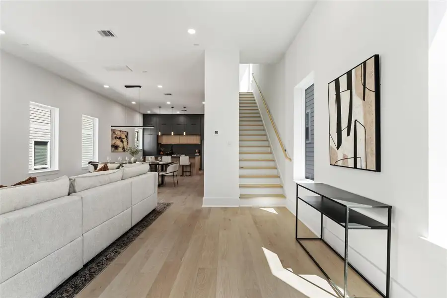 Sunlight traces a path from the stair hall to the culinary core, revealing the home’s precise geometry and wide-plank oak underfoot. The open second floor choreographs movement between spaces with quiet confidence—matte cabinetry, linear lighting, and crisp wall planes creating an atmosphere of refined, modern ease. Sunlight traces a path from the stair hall to the culinary core, revealing the home’s precise geometry and wide-plank oak underfoot. The open second floor choreographs movement between spaces with quiet confidence—matte cabinetry, linear lighting, and crisp wall planes creating an atmosphere of refined, modern ease.