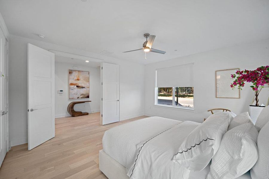Bedroom featuring light wood-style flooring and ceiling fan