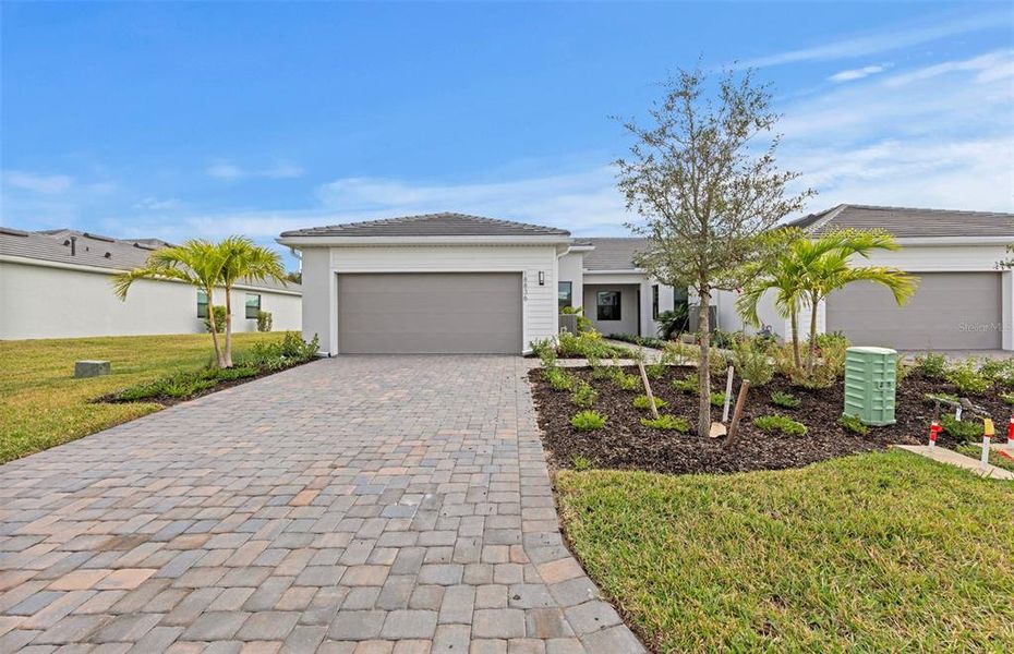 Front exterior of a new home in Del Webb Catalina, Lakewood Ranch, FL, highlighting curb appeal (Image 1). Front exterior of a new home in Del Webb Catalina, Lakewood Ranch, FL, highlighting curb appeal (Image 1).