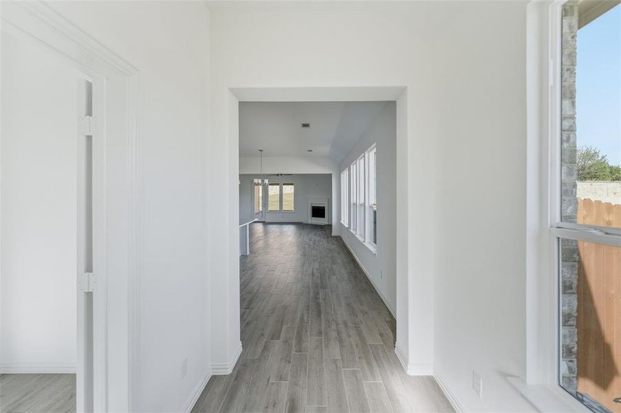 Hall featuring light wood-type flooring and baseboards